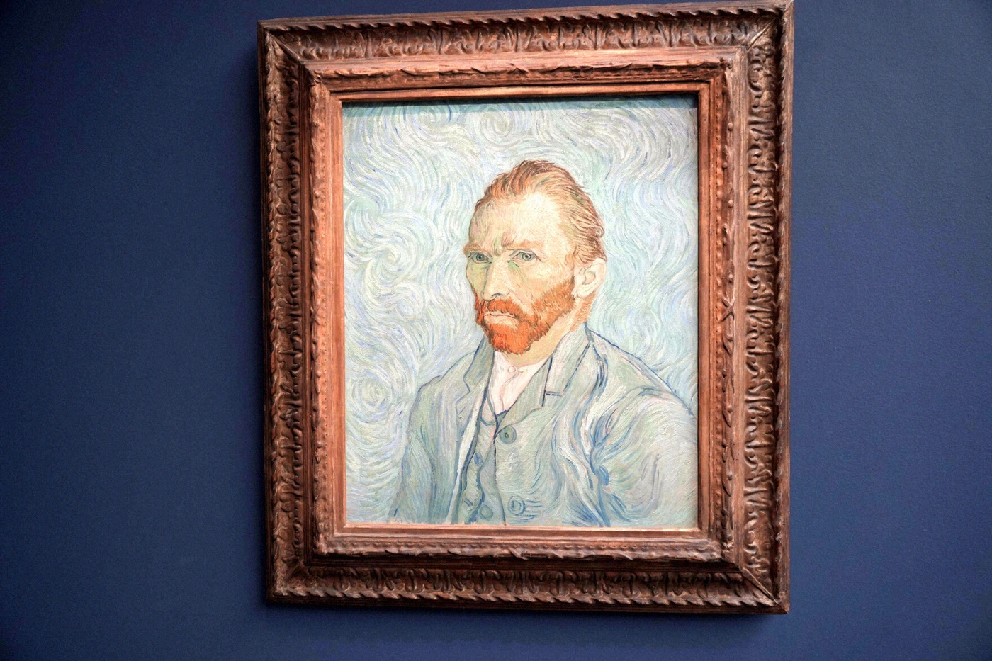 Van Gogh's famous 1889 self-portrait hangs in a dark blue-painted room of the Musée d'Orsay.